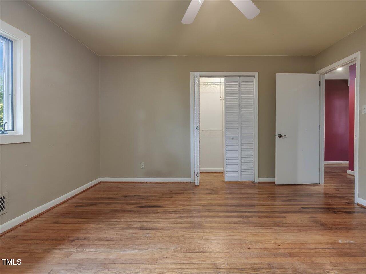 2129 Ridge Road Raleigh, NC 27607 - Photo 55 of 79 a view of an empty room with wooden floor and a window