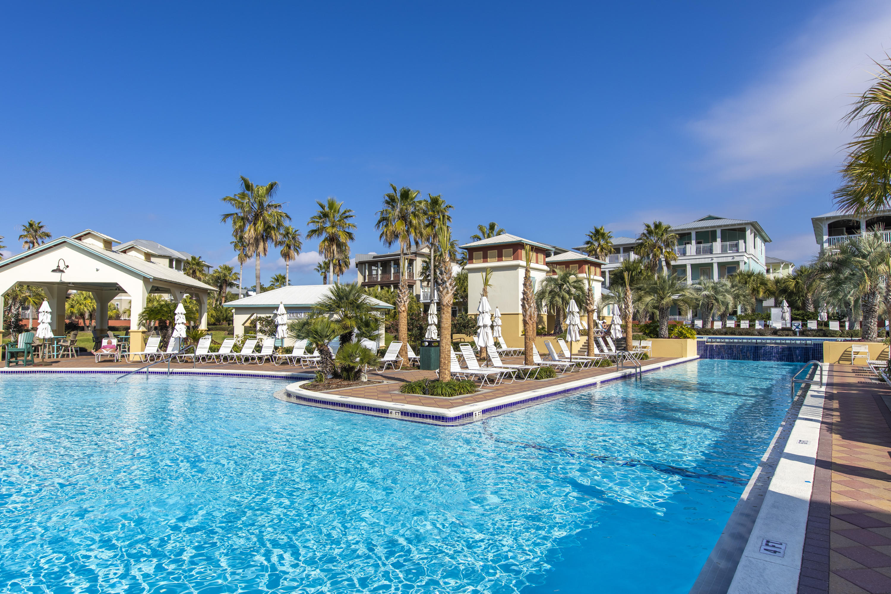 Lot 14 Block Q Blue Dolphin Ct Inlet Beach Inlet Beach, FL 32461 - Photo 12 of 14 a view of a swimming pool with a lawn chairs under an umbrella