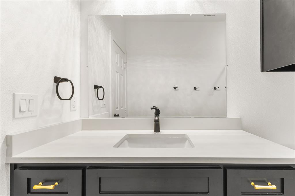101 Ross Street Sulphur Springs, TX 75482 - Photo 20 of 30 Bathroom with vanity and a textured wall