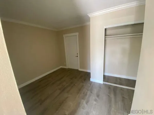 a view of a room with wooden floor