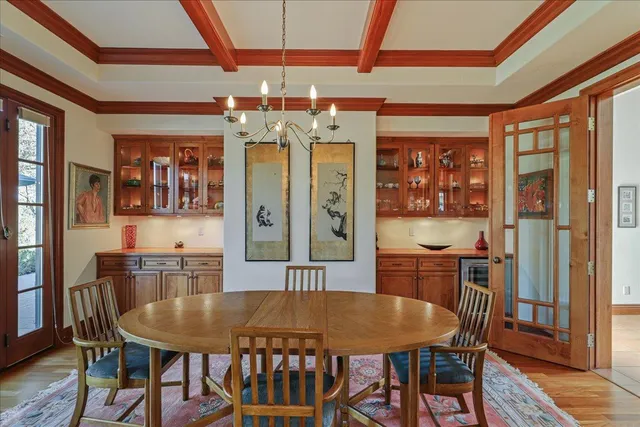 a living room with furniture and floor to ceiling windows