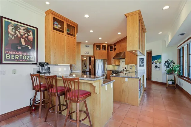 a living room with furniture a rug and a book shelf