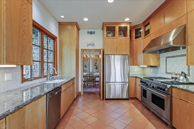 a living room with furniture a fireplace a potted plant and a large window