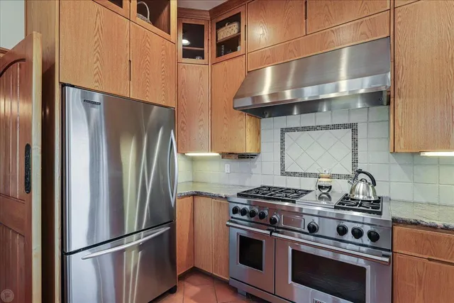 a living room with furniture a fireplace and potted plants