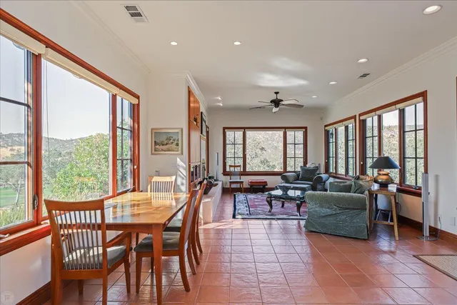 a living room with furniture a rug and a chandelier
