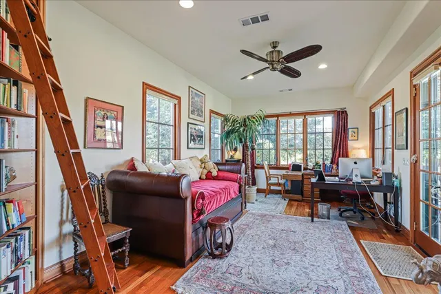 a view of staircase with lots of frames on wall and a window