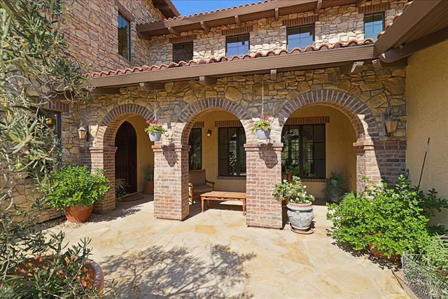 a dining room with furniture a chandelier and wooden floor