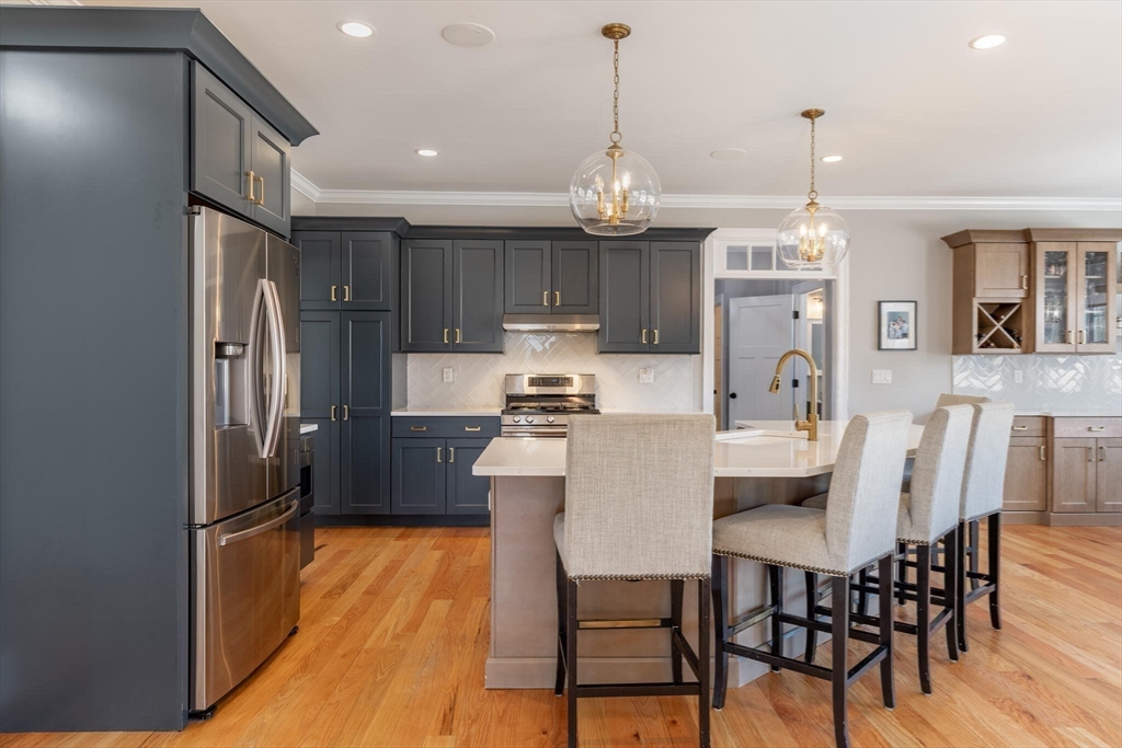 10 Rochambeau Avenue Wrentham, MA 02093 - Photo 11 of 40 a kitchen with stainless steel appliances a dining table chairs and refrigerator