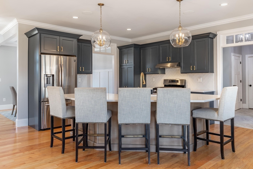 10 Rochambeau Avenue Wrentham, MA 02093 - Photo 12 of 40 a view of a dining room with furniture and wooden floor