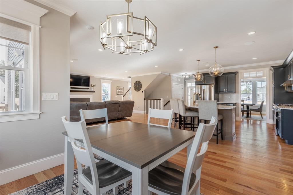 10 Rochambeau Avenue Wrentham, MA 02093 - Photo 17 of 40 a view of a dining room with furniture a chandelier and wooden floor