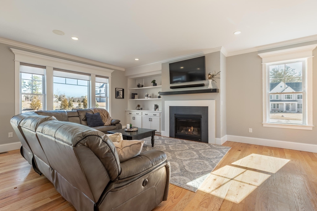 10 Rochambeau Avenue Wrentham, MA 02093 - Photo 19 of 40 a living room with furniture a flat screen tv and a fireplace