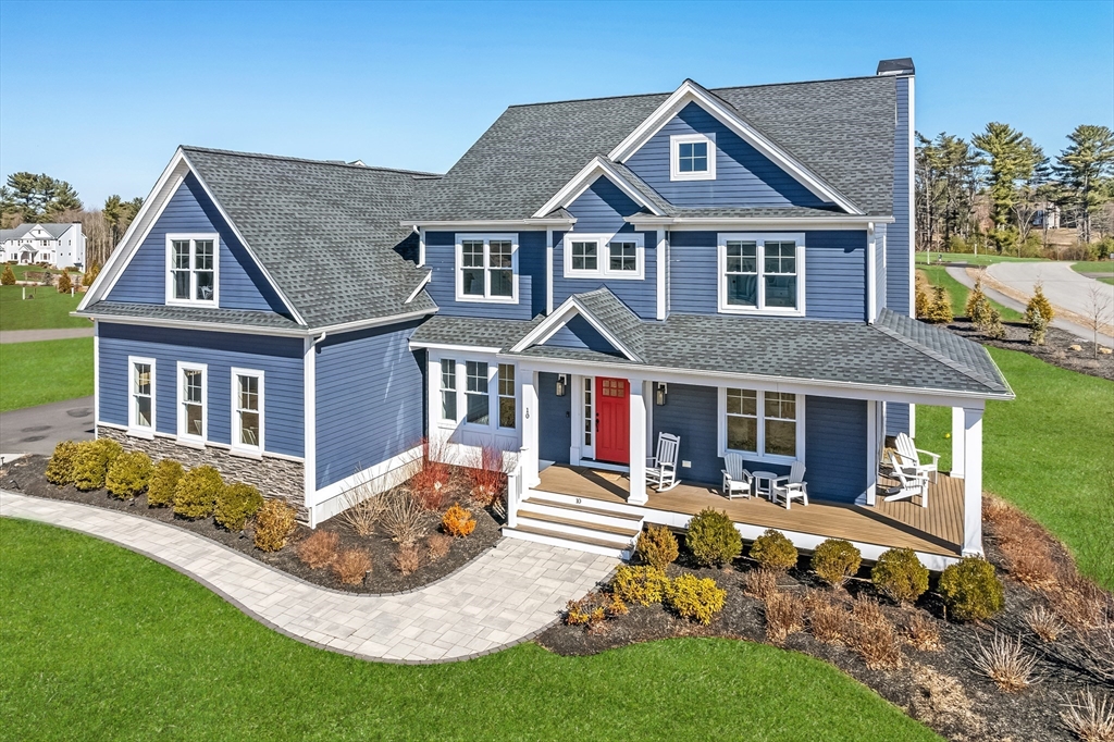 10 Rochambeau Avenue Wrentham, MA 02093 - Photo 2 of 40 a front view of a house with a yard table and chairs