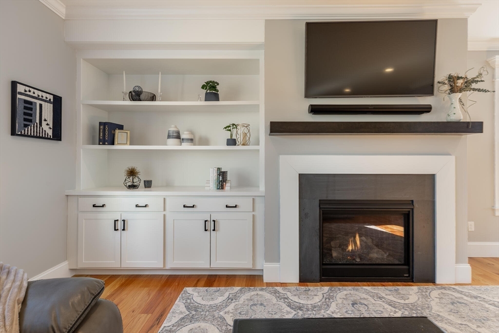 10 Rochambeau Avenue Wrentham, MA 02093 - Photo 21 of 40 a living room with white cabinets and a fireplace