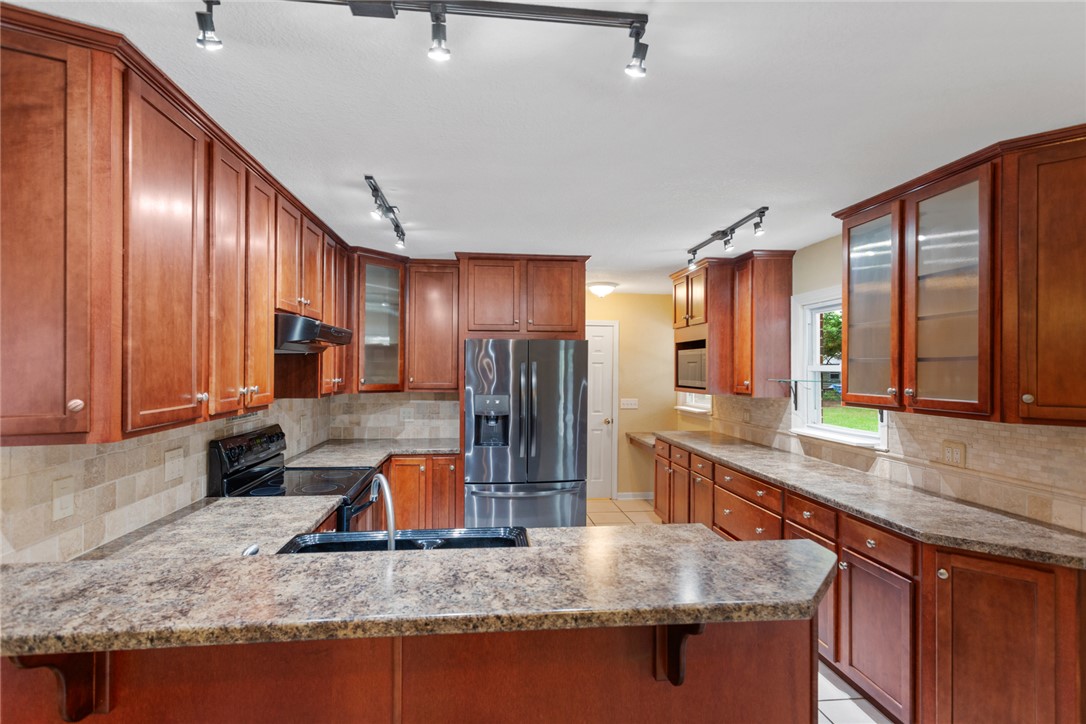 202 Keowee Trail Seneca, SC 29672 - Photo 6 of 35 This kitchen offers plentiful cabinetry and durable countertops, creating an inviting space for culinary endeavors.