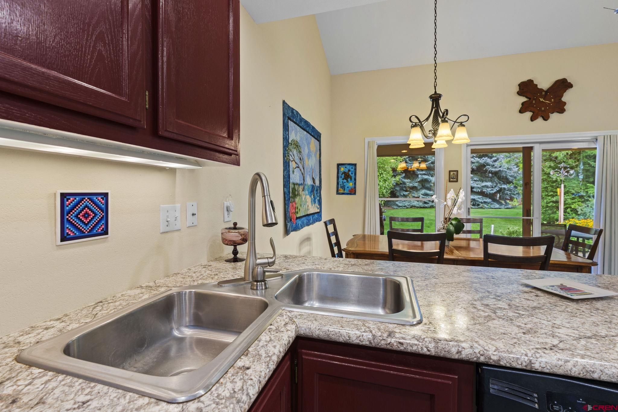 840 Waterfall Lane Durango, CO 81301 - Photo 11 of 31 a kitchen with granite countertop a sink and a counter top space