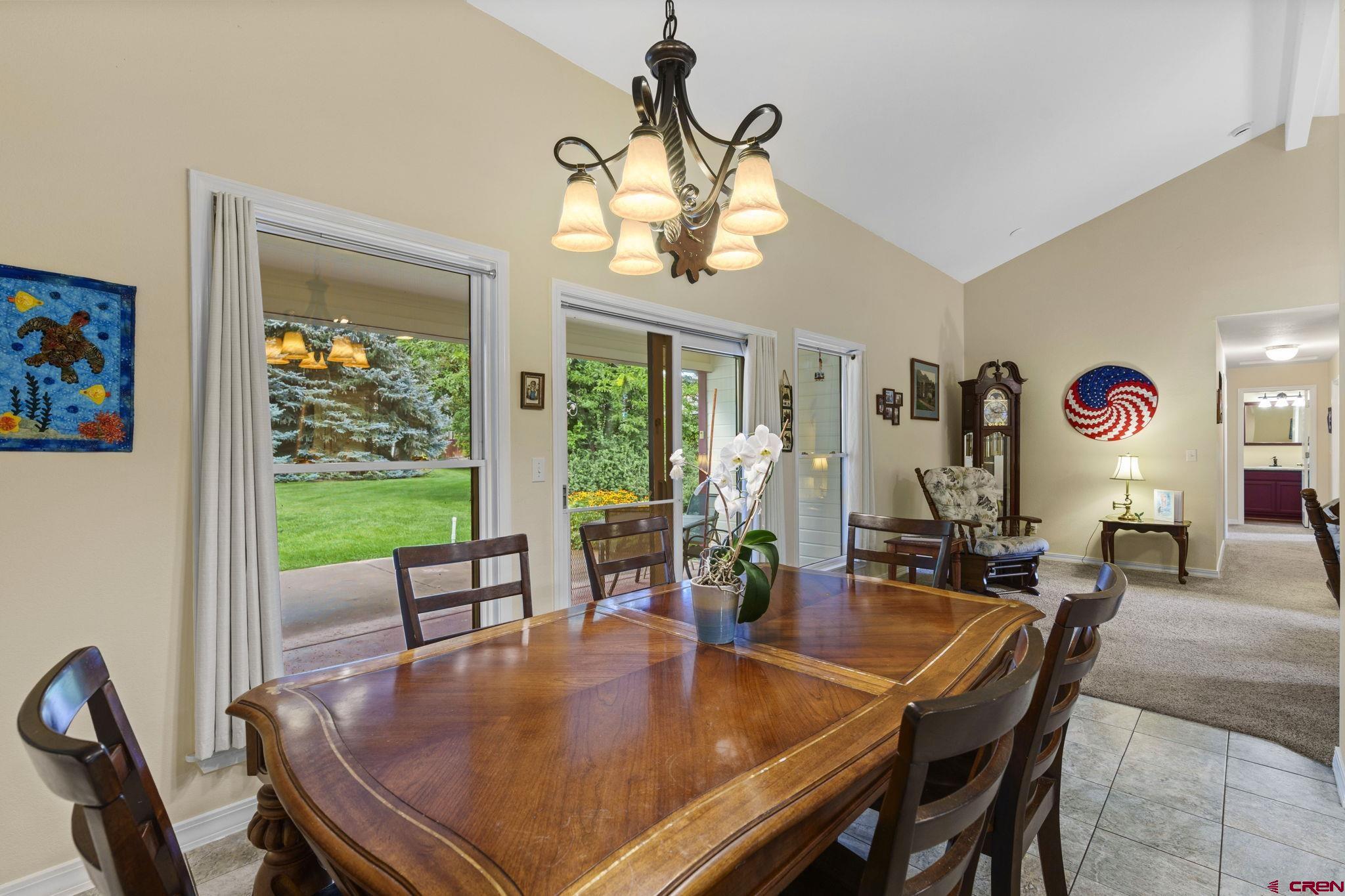 840 Waterfall Lane Durango, CO 81301 - Photo 12 of 31 a dining room with furniture a large window and a chandelier