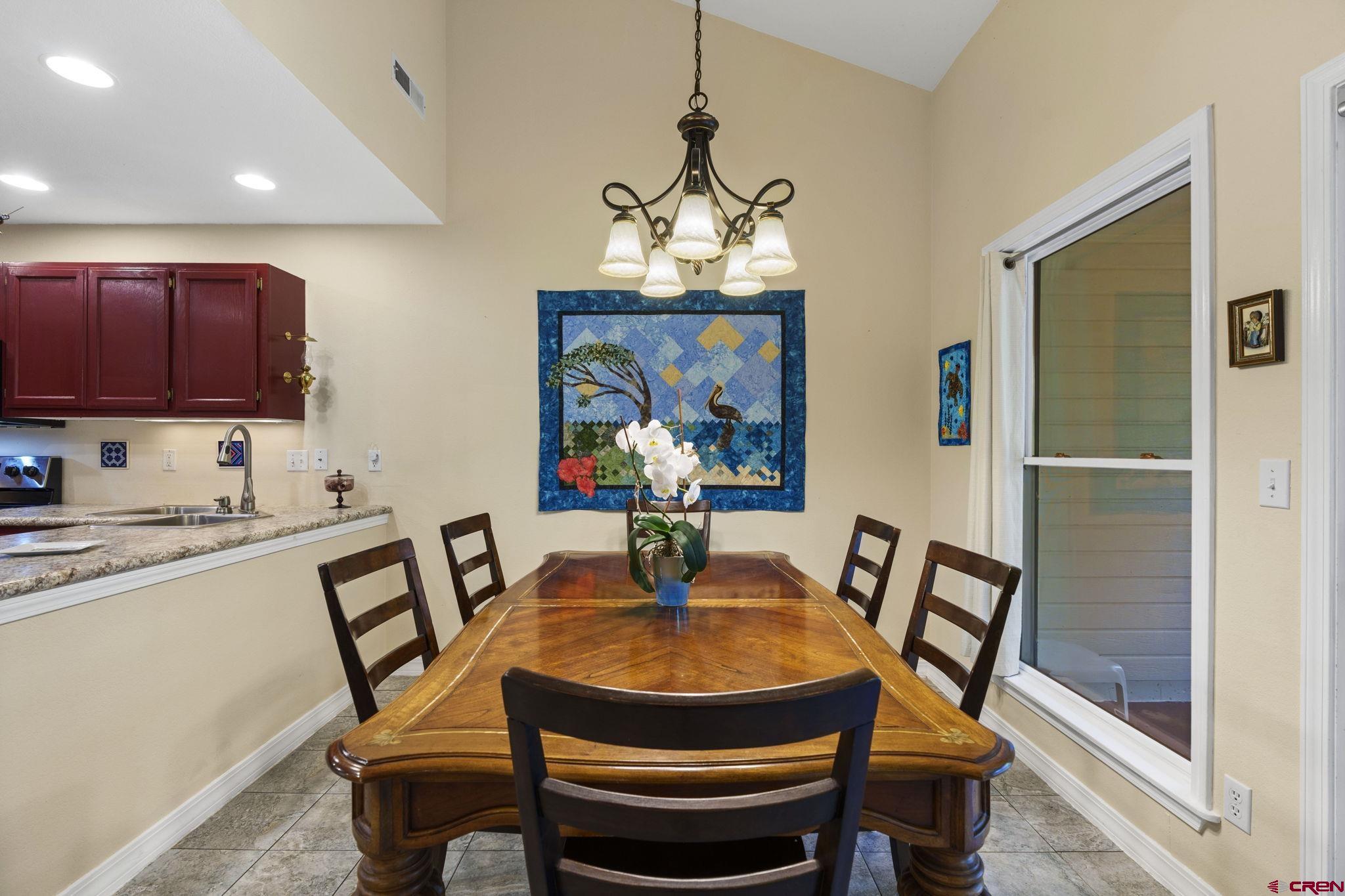 840 Waterfall Lane Durango, CO 81301 - Photo 13 of 31 a dining room with furniture a chandelier and window