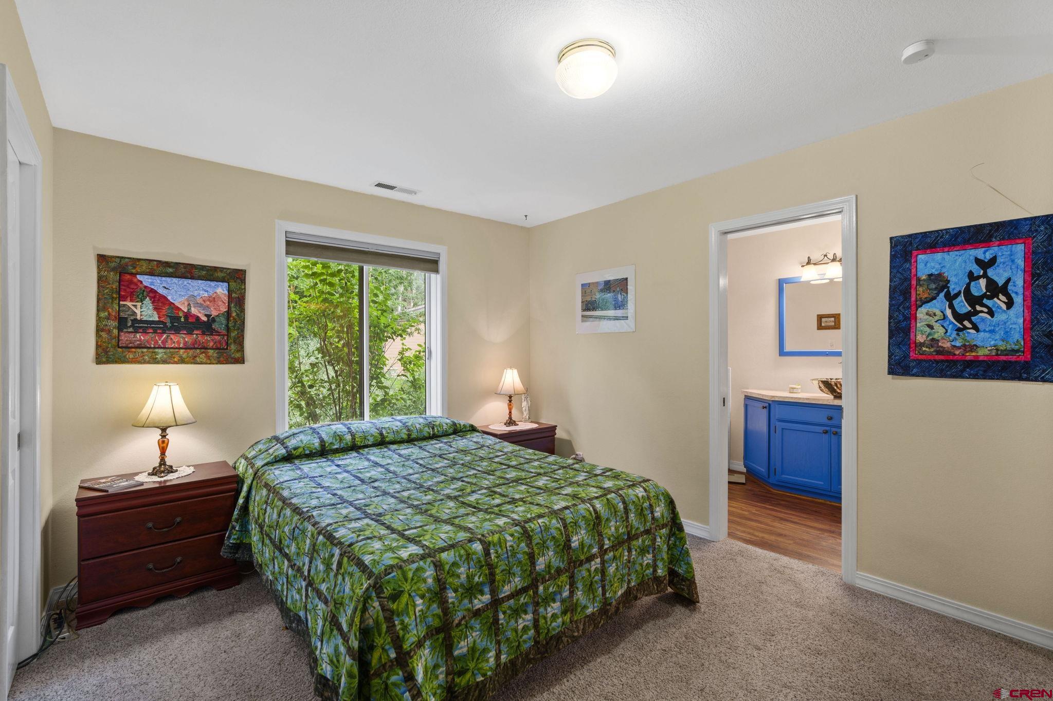 840 Waterfall Lane Durango, CO 81301 - Photo 16 of 31 a bedroom with a bed and a window