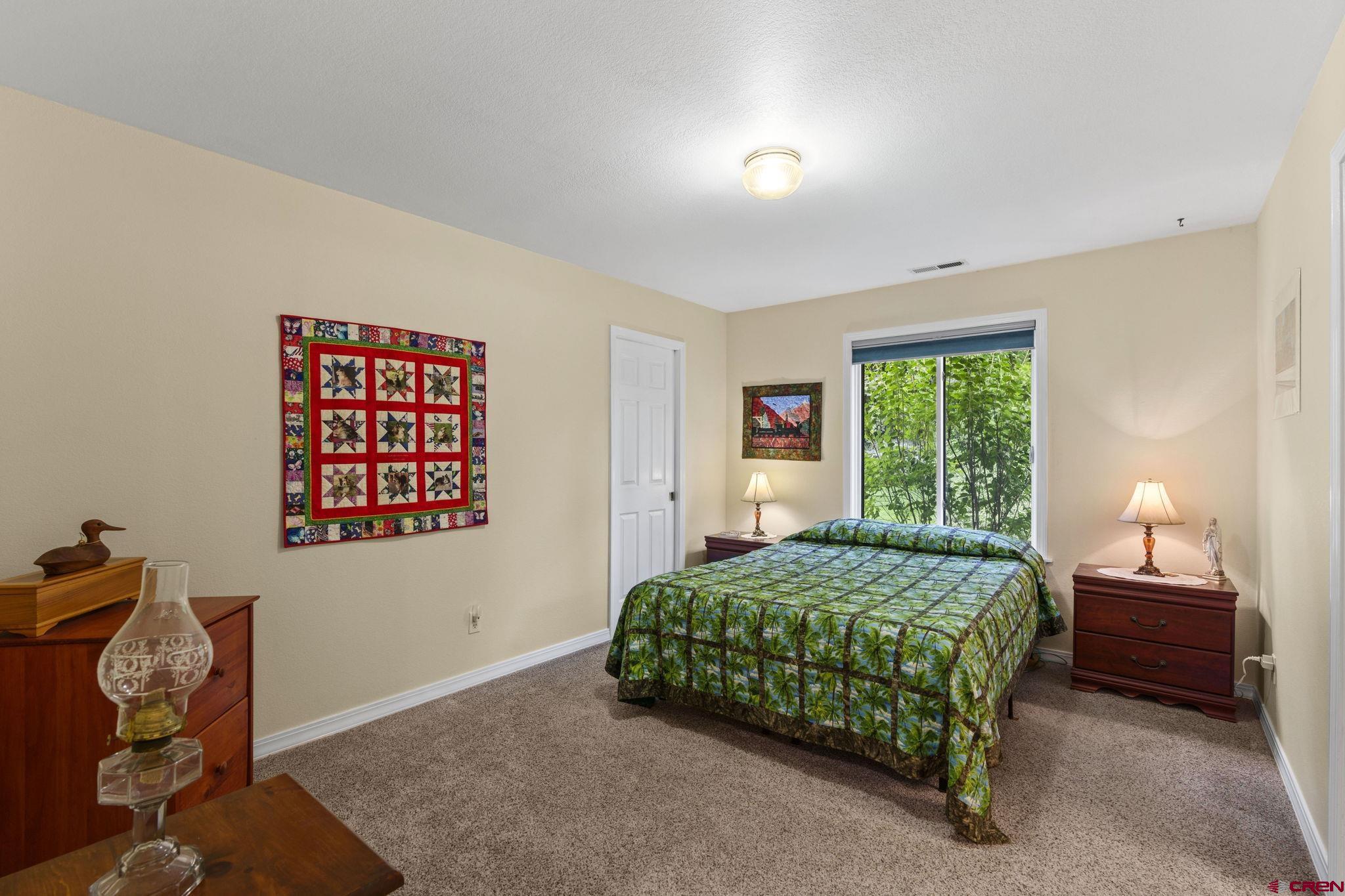 840 Waterfall Lane Durango, CO 81301 - Photo 17 of 31 a bedroom with a bed and a window