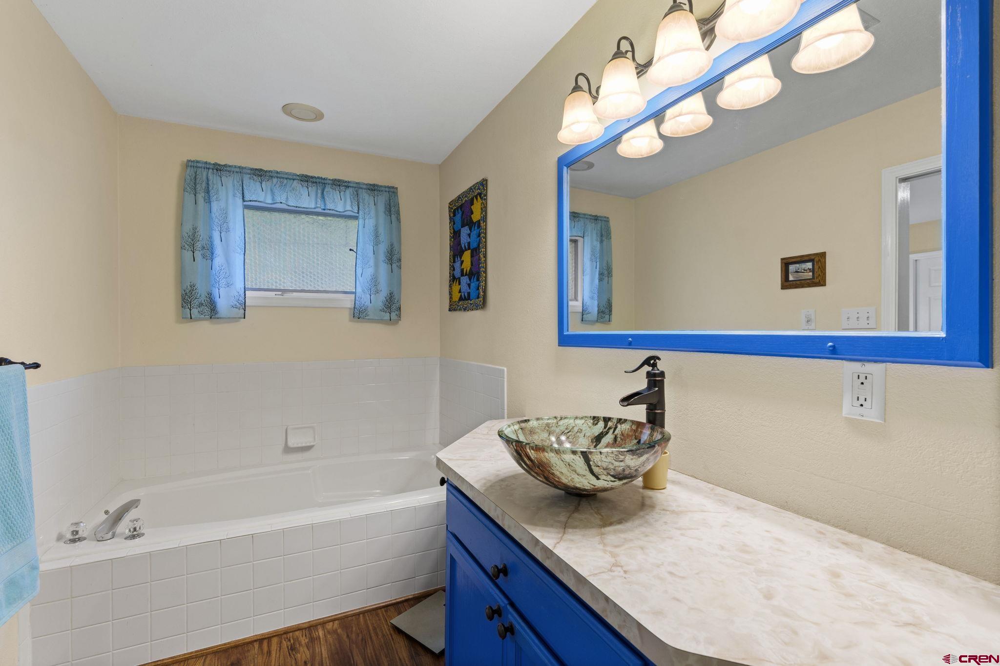 840 Waterfall Lane Durango, CO 81301 - Photo 19 of 31 a bathroom with a granite countertop sink and a mirror