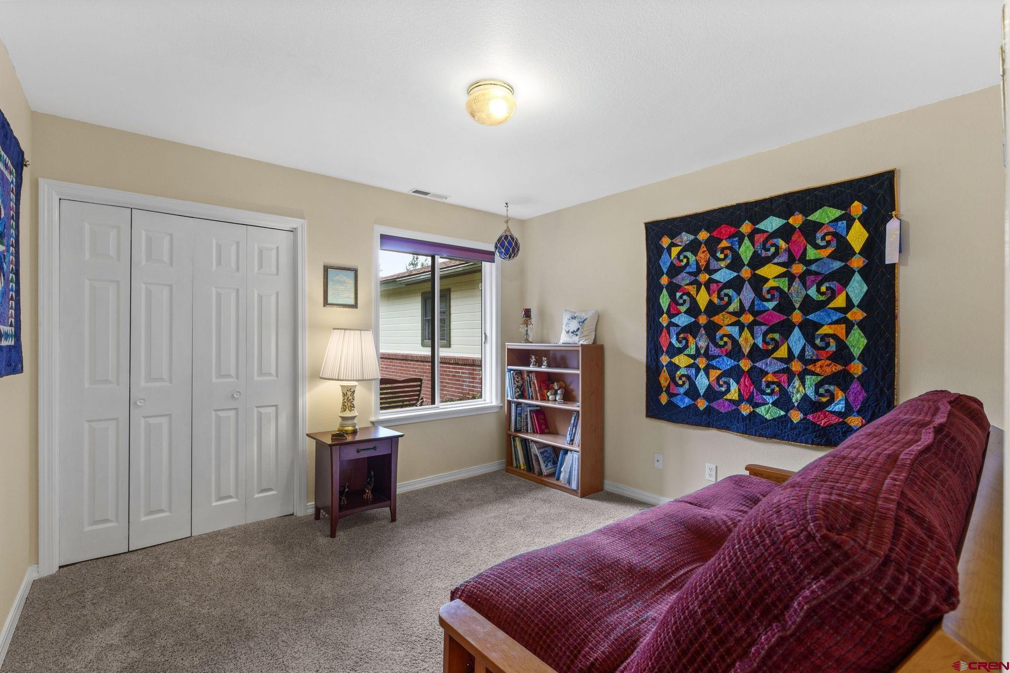 840 Waterfall Lane Durango, CO 81301 - Photo 20 of 31 a living room with furniture and a baby crib