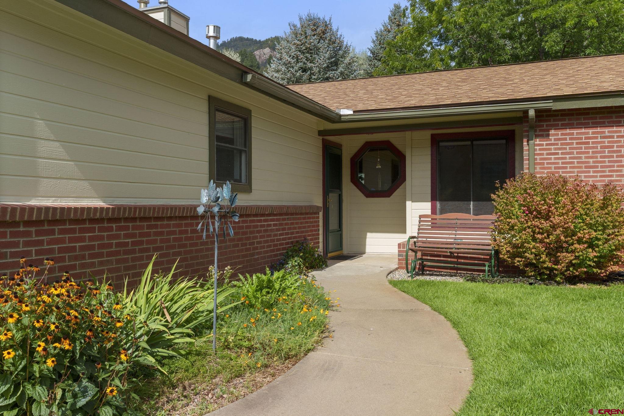 840 Waterfall Lane Durango, CO 81301 - Photo 2 of 31 a front view of a house with garden