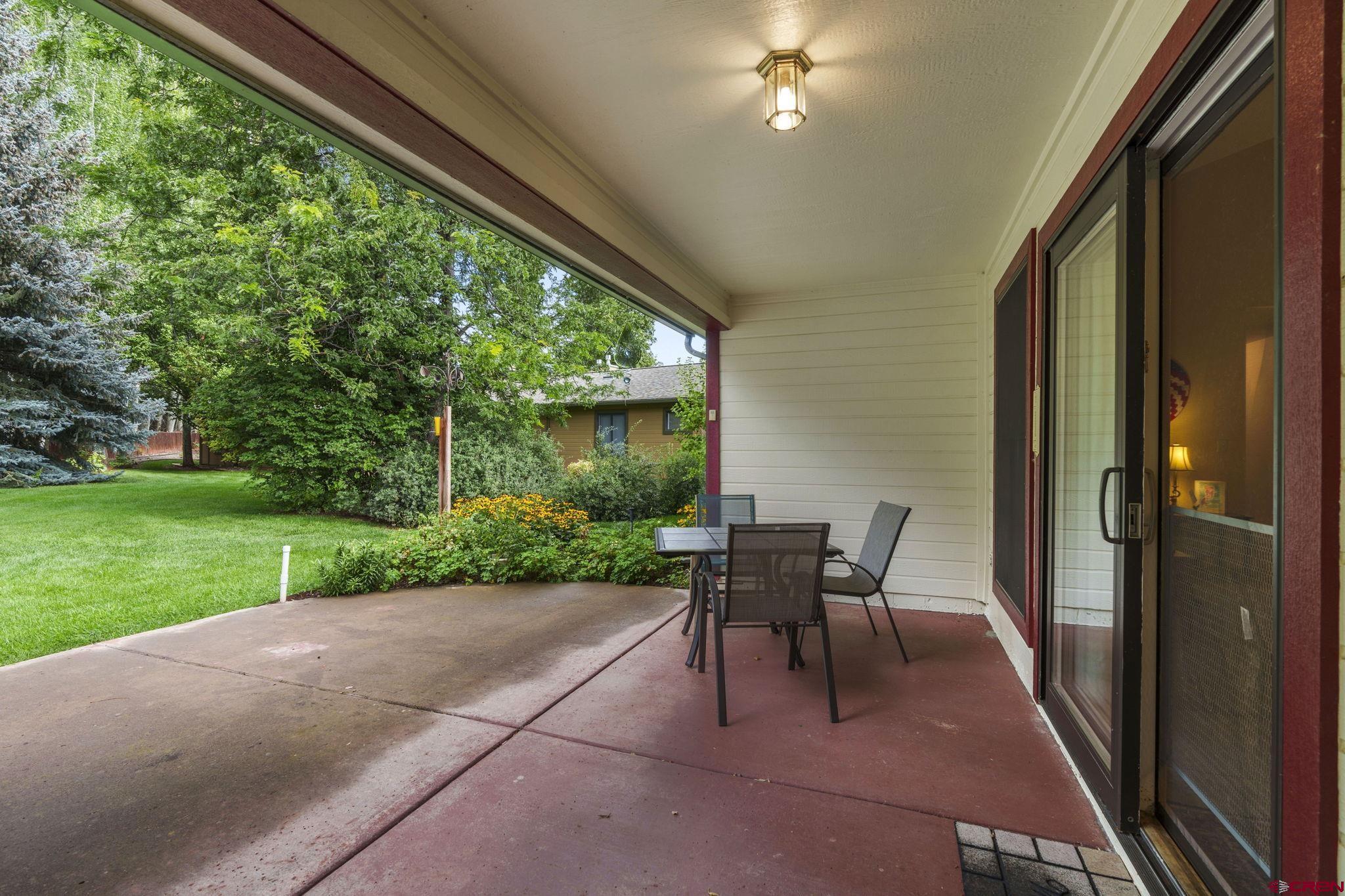 840 Waterfall Lane Durango, CO 81301 - Photo 27 of 31 a view of a patio with a table chairs and backyard