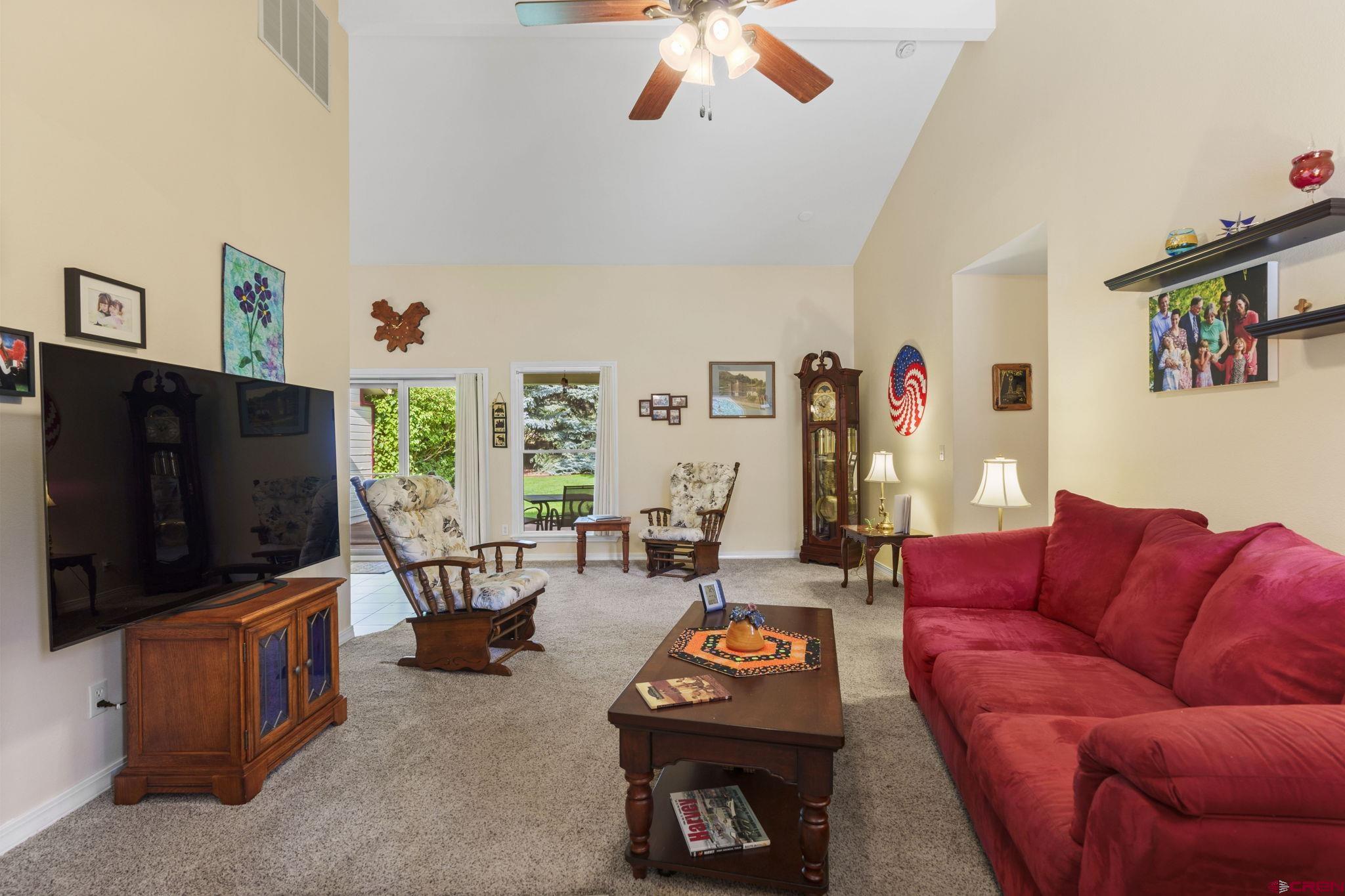840 Waterfall Lane Durango, CO 81301 - Photo 5 of 31 a living room with furniture and a flat screen tv