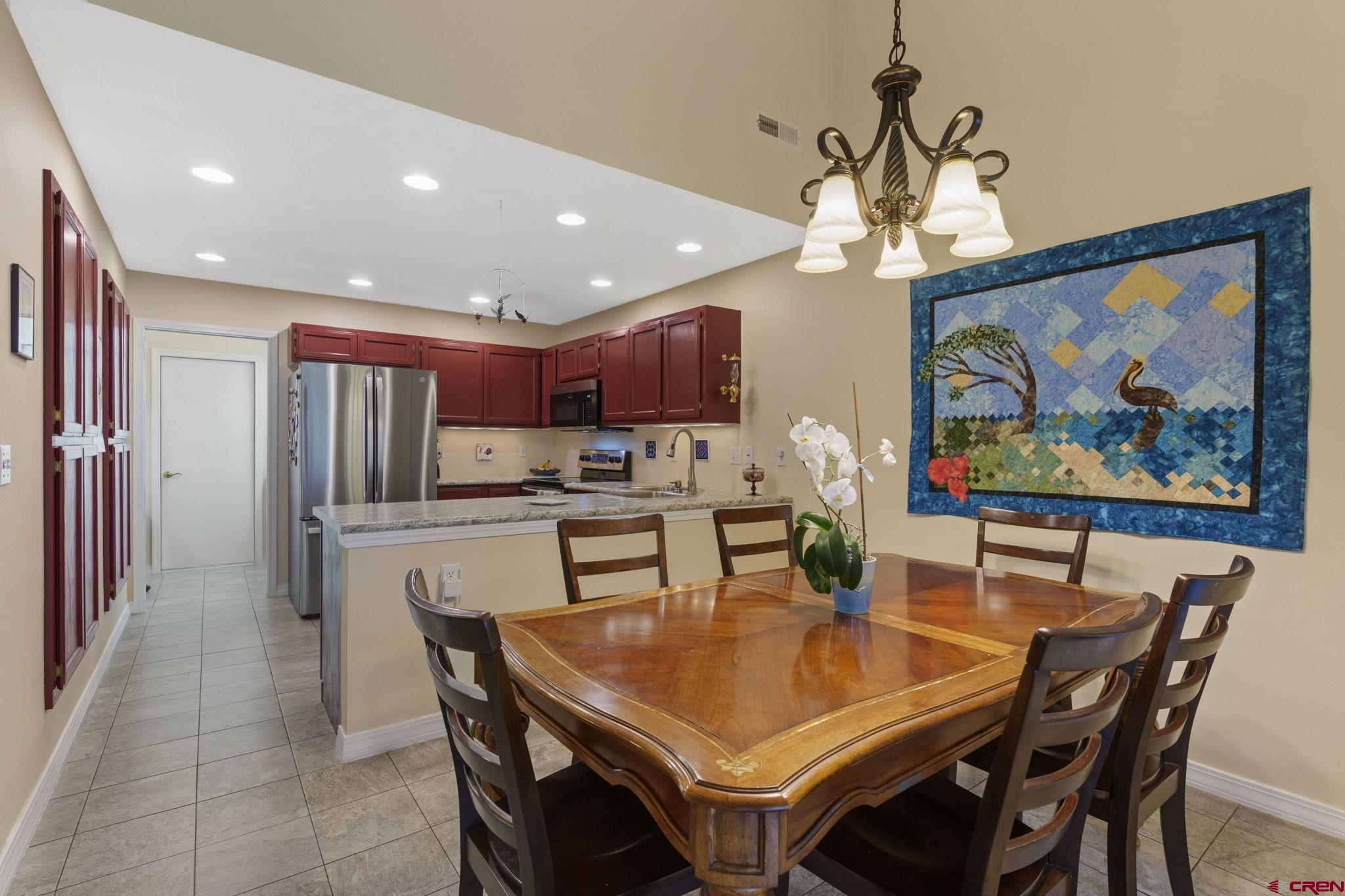 840 Waterfall Lane Durango, CO 81301 - Photo 8 of 31 a dining room with stainless steel appliances furniture a chandelier and kitchen view