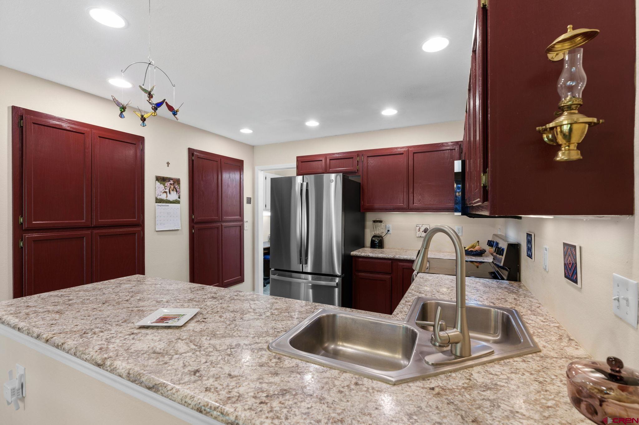 840 Waterfall Lane Durango, CO 81301 - Photo 9 of 31 a kitchen with stainless steel appliances granite countertop a sink refrigerator and microwave