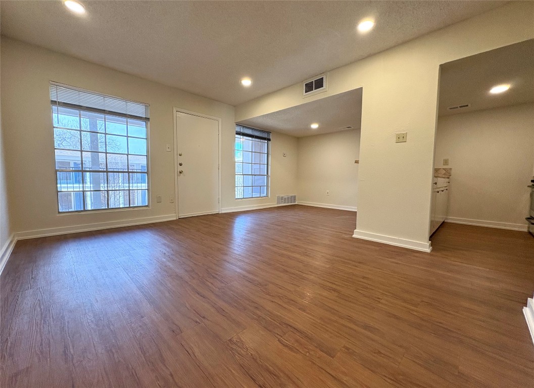 4709 Harmon Avenue, Unit 421 Austin, TX 78751 - Photo 3 of 11 an empty room with wooden floor and windows