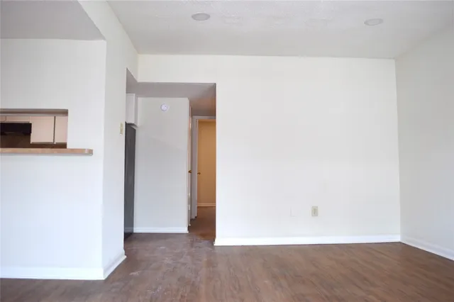 a view of a room with wooden floor