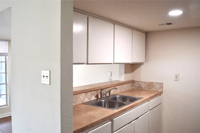 a kitchen with a sink and cabinets