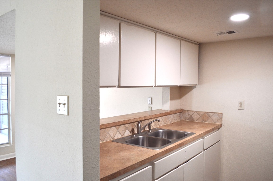 4709 Harmon Avenue, Unit 421 Austin, TX 78751 - Photo 6 of 11 a kitchen with a sink and cabinets