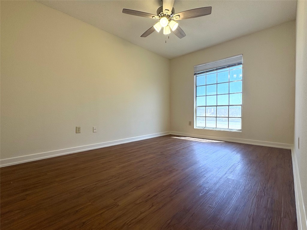 4709 Harmon Avenue, Unit 421 Austin, TX 78751 - Photo 8 of 11 a view of an empty room with wooden floor and a window