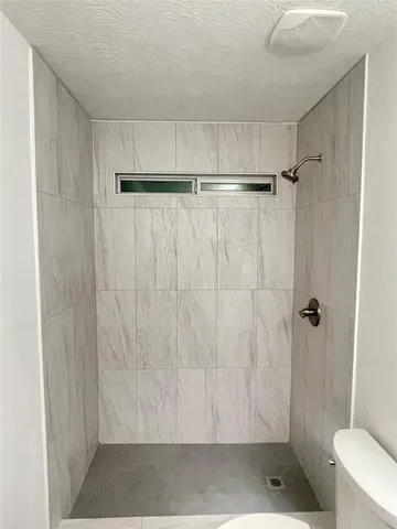 a bathroom with a shower and a toilet