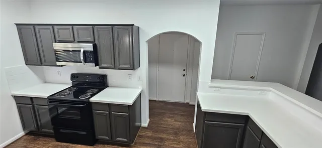 a kitchen with a sink cabinets and stainless steel appliances