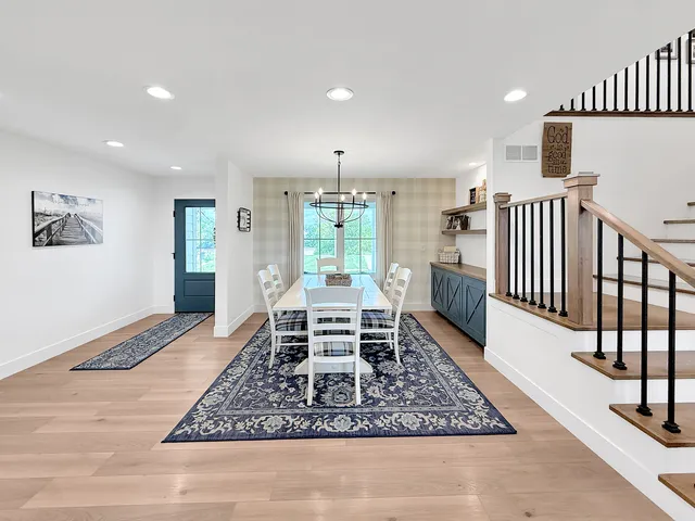a living room with furniture fireplace and kitchen view