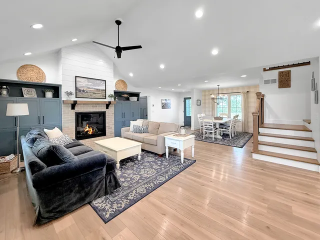 a large kitchen with kitchen island a large counter space a sink stainless steel appliances and cabinets