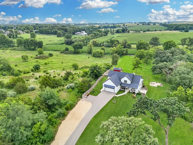 an aerial view of a house with a yard