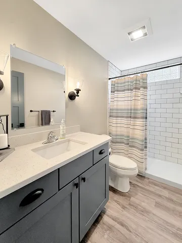 a view of a green yard with large trees