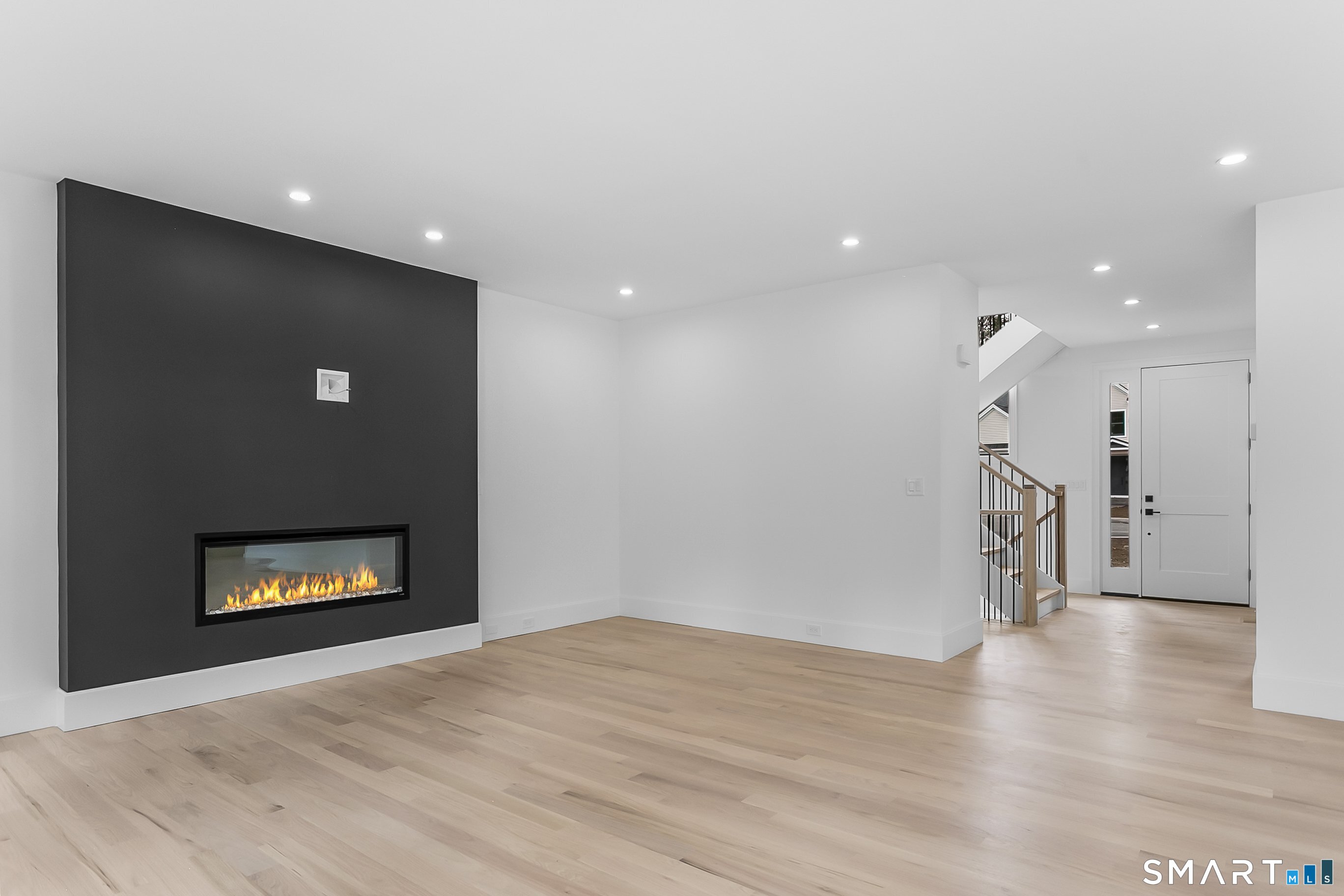 95 Oronoque Lane Stratford, CT 06614 - Photo 13 of 30 a view of empty room with wooden floor and fireplace