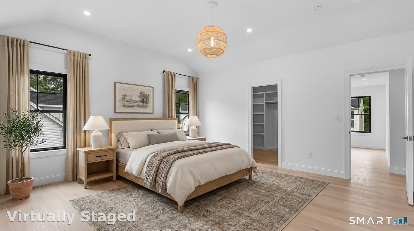 95 Oronoque Lane Stratford, CT 06614 - Photo 16 of 30 a bedroom with a bed a mirror and a potted plant