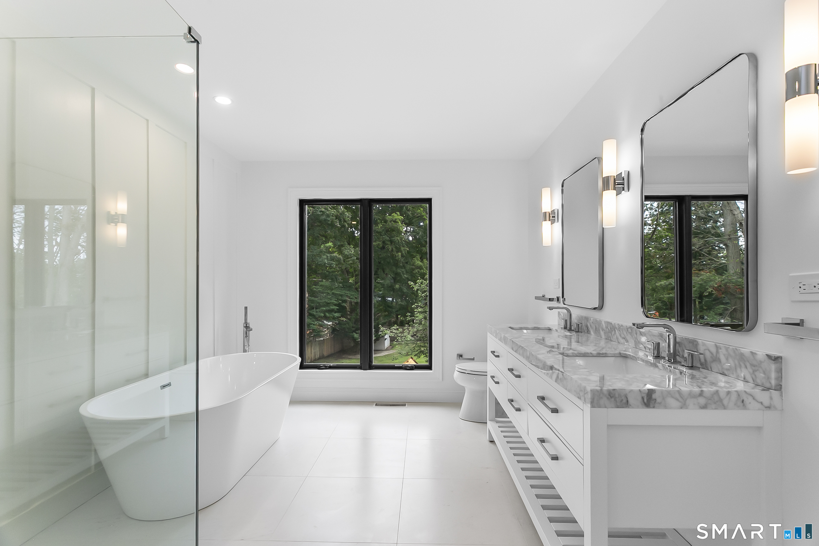 95 Oronoque Lane Stratford, CT 06614 - Photo 21 of 30 a spacious bathroom with a tub sink and mirror