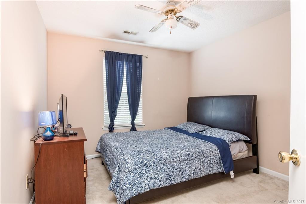 3821 Rosedown Drive Matthews, NC 28105 - Photo 12 of 19 a bedroom with a bed and wooden floor