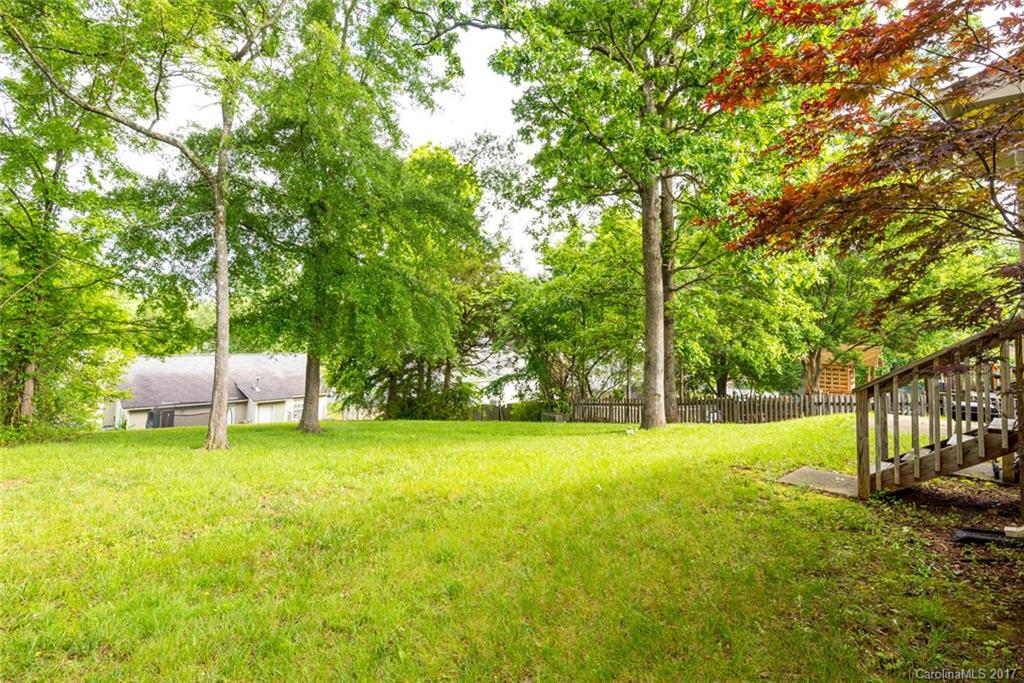 3821 Rosedown Drive Matthews, NC 28105 - Photo 18 of 19 a view of a yard with a house and large trees