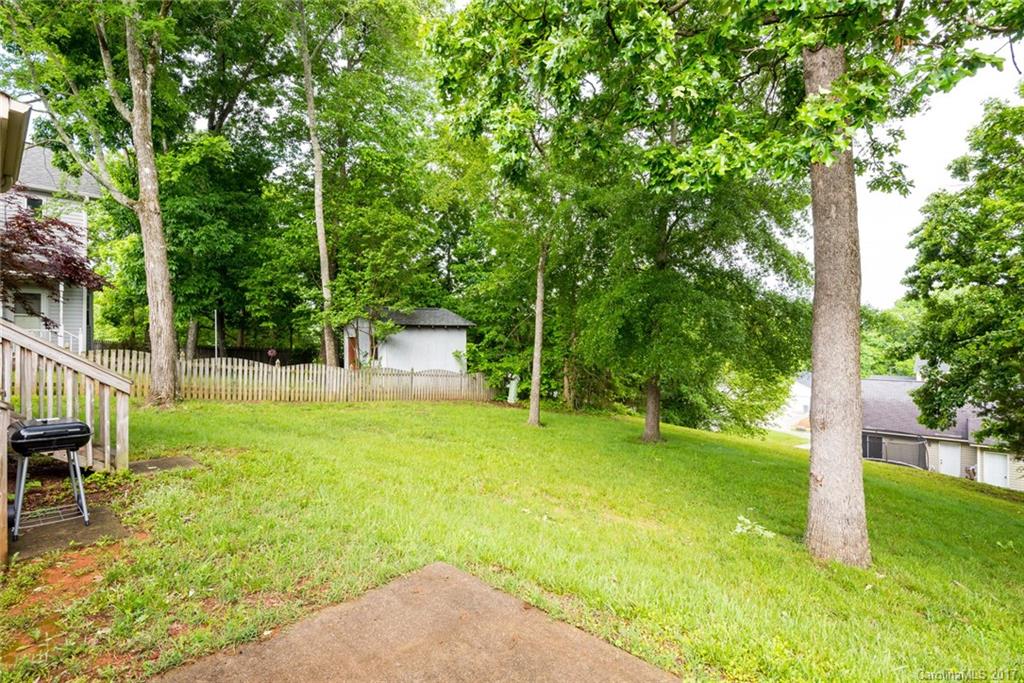 3821 Rosedown Drive Matthews, NC 28105 - Photo 19 of 19 a backyard of a house with plants and large trees