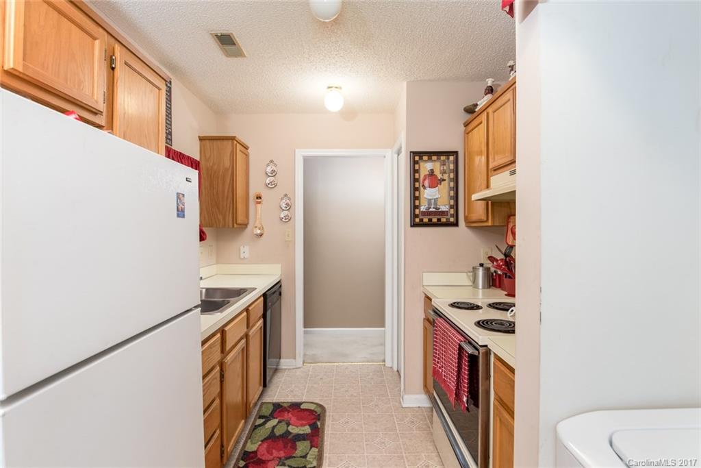 3821 Rosedown Drive Matthews, NC 28105 - Photo 7 of 19 a kitchen with a sink a stove and a refrigerator