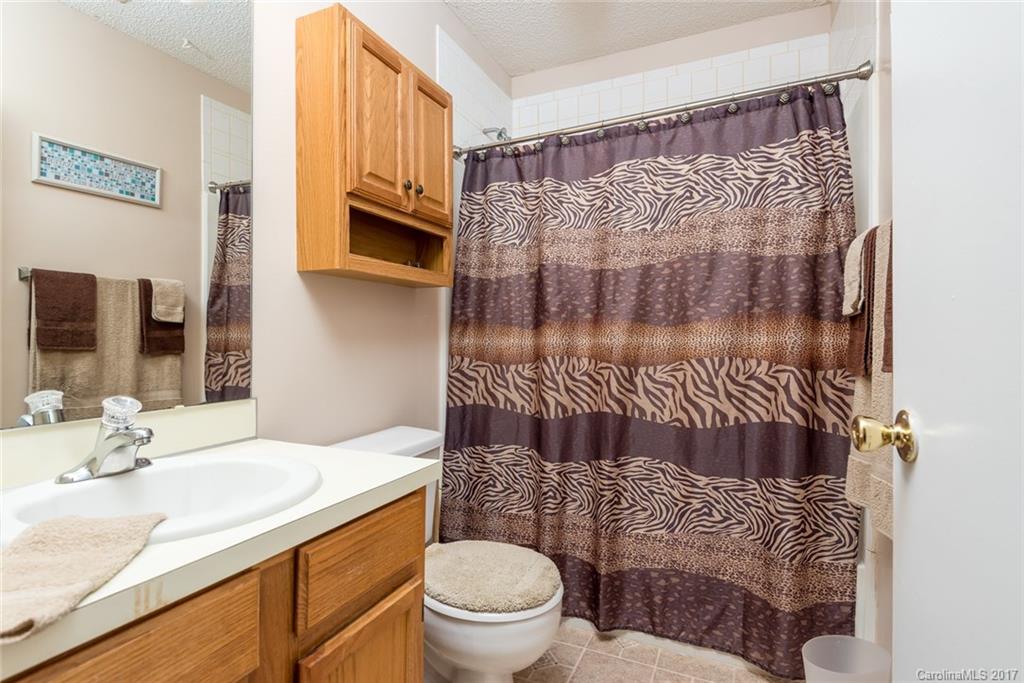 3821 Rosedown Drive Matthews, NC 28105 - Photo 10 of 19 a bathroom with a granite countertop bathtub sink vanity mirror and toilet