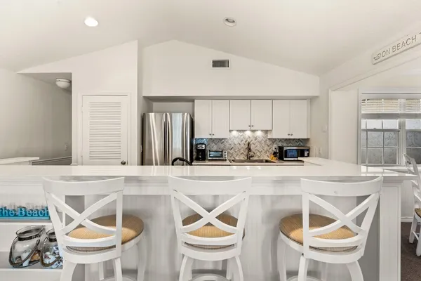 a kitchen with a stove a table and chairs